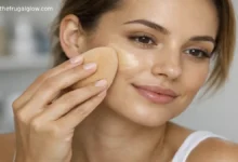 A woman applying drugstore liquid foundation with a damp makeup sponge for a smooth, airbrushed finish