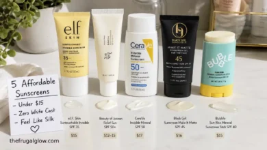 Five affordable sunscreens arranged on a white surface: e.l.f. Suntouchable, Beauty of Joseon Relief Sun, CeraVe Invisible Mineral, Black Girl Sunscreen, and Bubble Sun Rise Stick. A sign says "Under $15 – Zero White Cast."