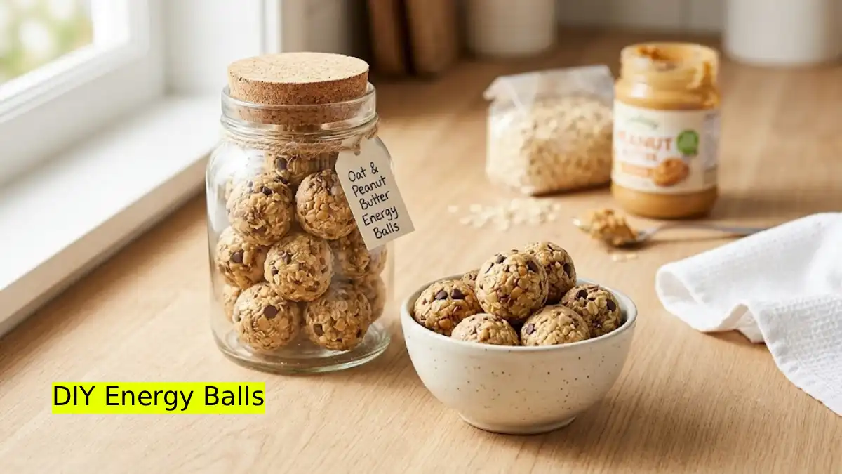 A glass jar and bowl filled with homemade oat and peanut butter energy balls on a kitchen counter.
