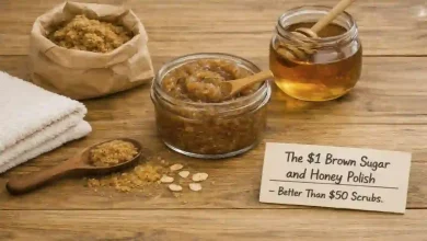 A small bowl of brown sugar and honey scrub next to a bag of brown sugar and a jar of honey. A sign says "$1 vs $50 – Same soft skin."