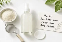 A glass spray bottle filled with homemade rice water toner next to a bowl of rice, a strainer, and a cotton pad. A sign says "$0 vs $45 – Same Glow."
